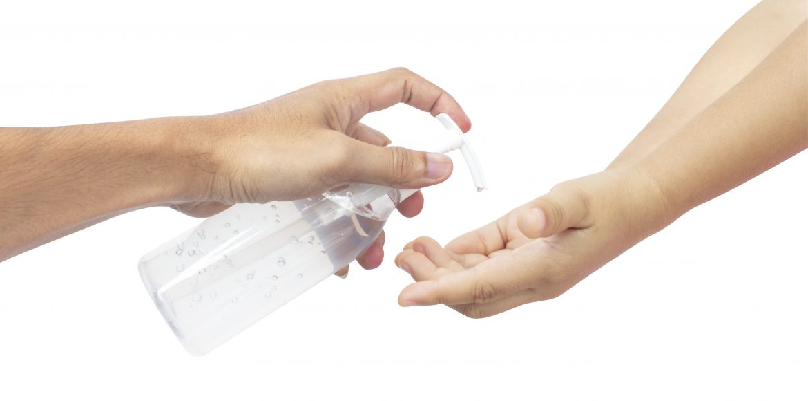 Man using squeezing hand sanitizer to palm kid. Sanitizing hands to protect from getting flu. Antibacterial antiseptic on white background clipping path.