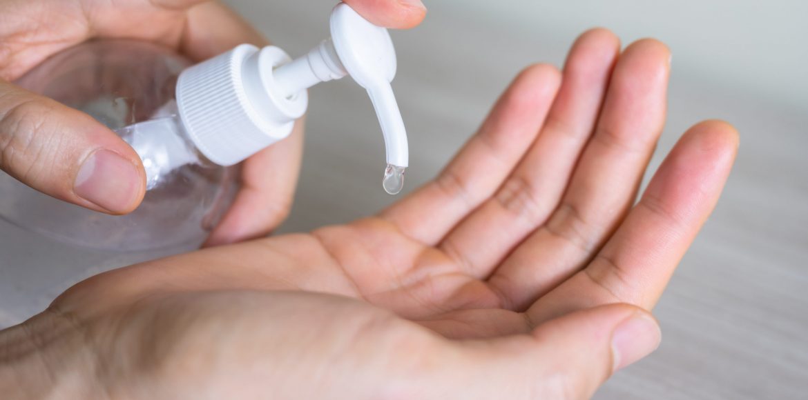 Man washing hands with sanitizer gel bottle or soap for coronavirus prevention, hygiene to stop spreading covid-19 (select focus)